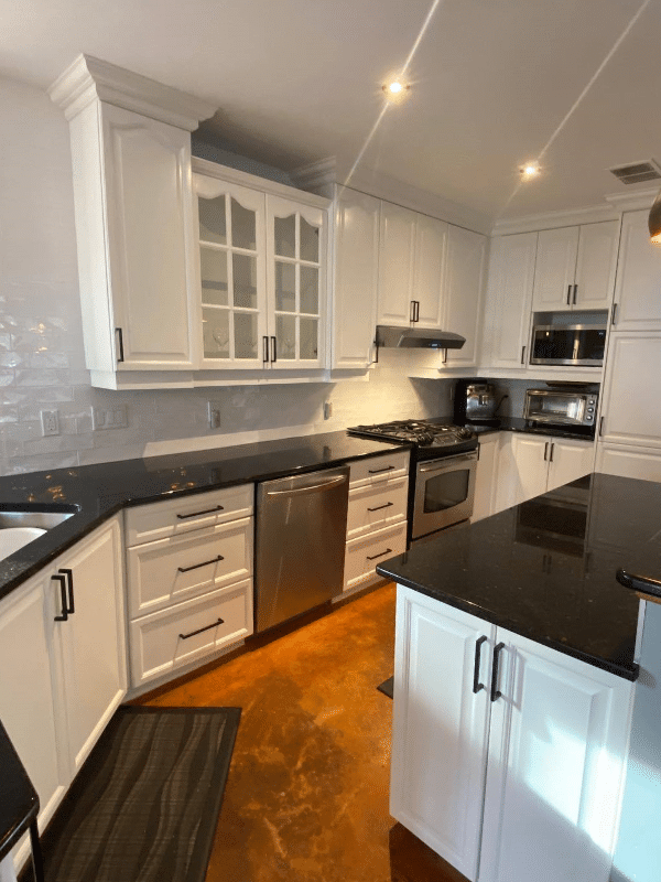 Freshly painted white kitchen cabinets in a modern kitchen.