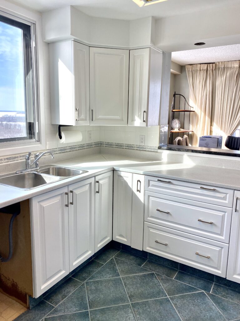 Freshly painted white kitchen cabinets in a modern kitchen.